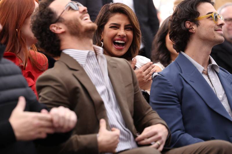 Priyanka Chopra laughs along with Nick Jonas. Reuters