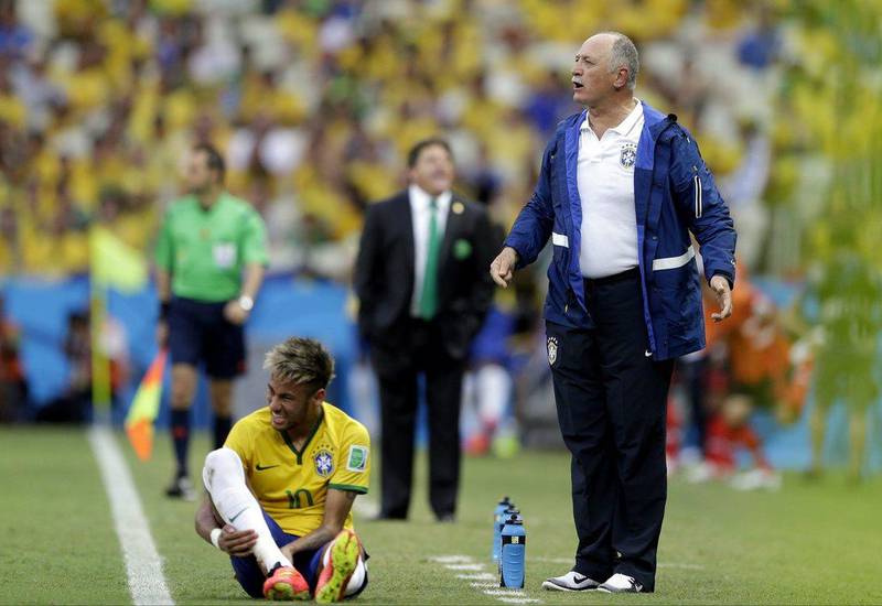 Luiz Felipe Scolari stands on the touchline with Neymar during Brazil's draw with Mexico on Tuesday night at the 2014 World Cup. Andre Penner / AP / June 17, 2014