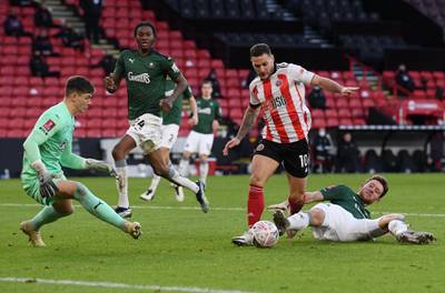 Sheffield United's Billy Sharp evades the challenge of Will Aimson on his way to scoring his team's second. Getty