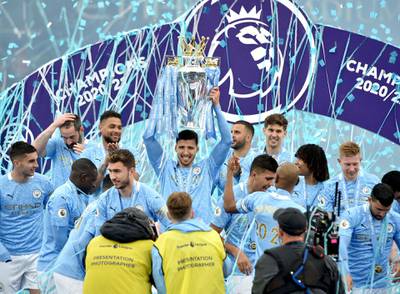 Manchester City players lift the Premier League Trophy at the Etihad Stadium. PA