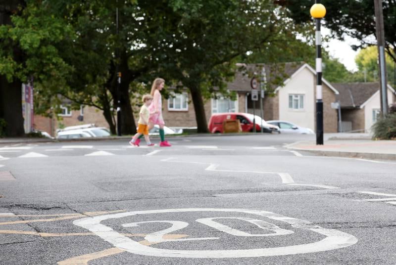 Signs limit traffic to 20 miles per hour on a road in London, on October 01. EPA