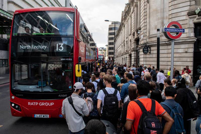 Commuters queue for buses outside Victoria underground train station. Getty Images