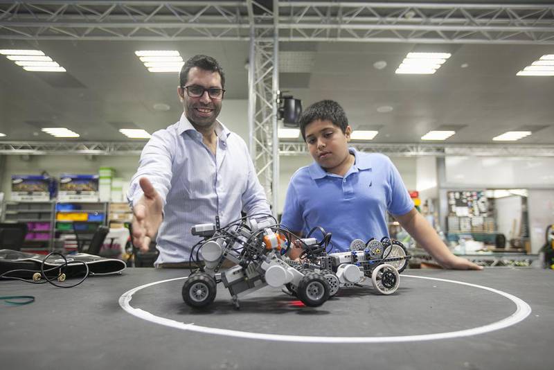 Georgios Korres, a research engineer at NYUAD, and Ibrahim Nayfeh with their robots. Mona Al Marzooqi / The National