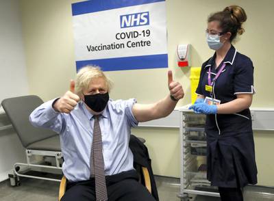 LONDON, ENGLAND - MARCH 19: Britain's Prime Minister Boris Johnson gestures after receiving the first dose of AstraZeneca vaccine administered by nurse and Clinical Pod Lead, Lily Harrington at St.Thomas' Hospital on March 19, 2021 in London, England. Johnson is one of several politicians across Europe, including French Prime Minister Jean Castex, getting a shot of the AstraZeneca vaccine on Friday. (Photo by Frank Augstein-WPA Pool/Getty Images)