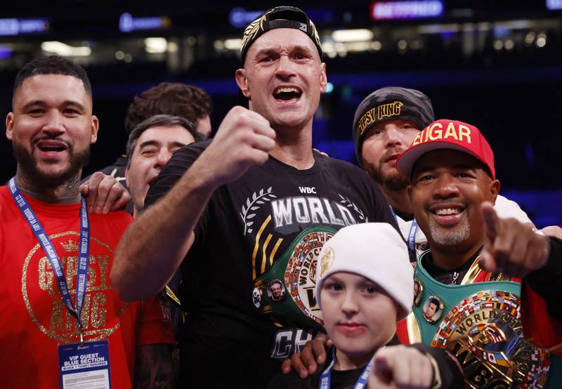 Tyson Fury celebrates with his team and son after winning his fight against Derek Chisora. Reuters