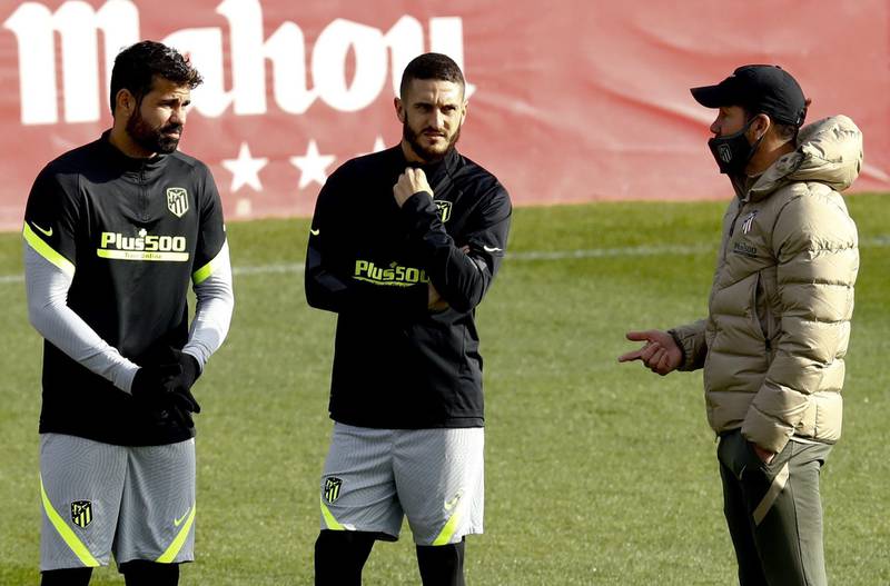 Atletico manager Diego Simeone talking to Diego Costa, left, and Koke. EPA