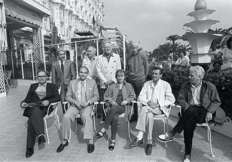 Members of the jury (front row L-R), Italian composer Ennio Morricone, US film director Stanley Donen, French actress Isabelle Huppert, British actor Dirk Bogarde, Spanish writer Jorge Semprun ; (back row L-R), Italian producer Franco Cristaldi, Soviet photo director Vadim Yusov, Norwegian journalist Arne Hestenes, and French director Michel Deville, pose 10 May 1984 during the Cannes International Film Festival. (Photo by RALPH GATTI / AFP)