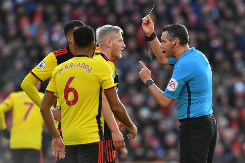 Watford's Will Hughes gets a yellow card. AFP