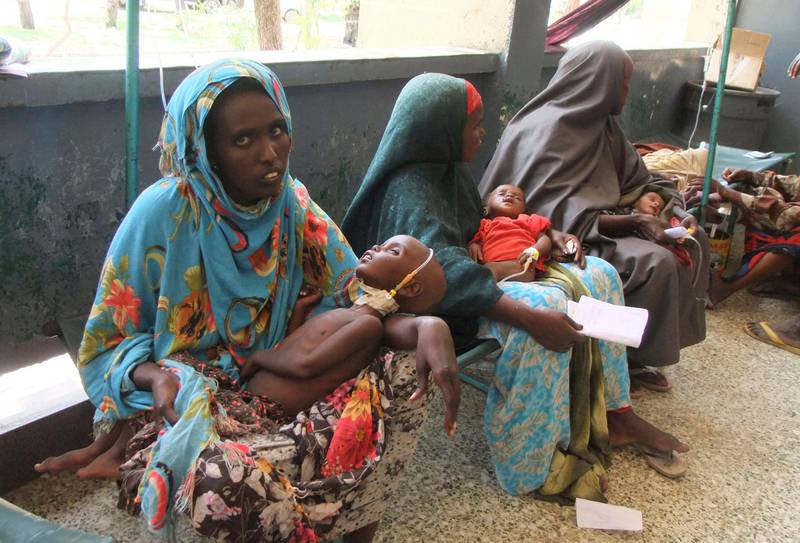 Mothers from southern Somalia hold their malnourished children at  Banadir hospital in Mogadishu, Somalia, Monday, July 25, 2011. Some thousands of people have arrived in Mogadishu seeking aid, and The World Food Program executive director Josette Sheeran said Saturday they can't reach the estimated 2.2 million Somalis in desperate need of aid who are in militant-controlled areas of Somalia.(AP Photo/Farah Abdi Warsameh)                