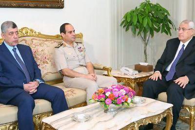 A picture released by the Egyptian presidency shows Egypt's interim president Adly Mansour (right) meeting with defence minister Gen Abdel Fattah El Sisi (centre) and Egyptian interior minister Mohammed Ibrahim (left) in Cairo on Monday.  The EU is to meet tomorrow to discuss the future of Egypt’s aid.