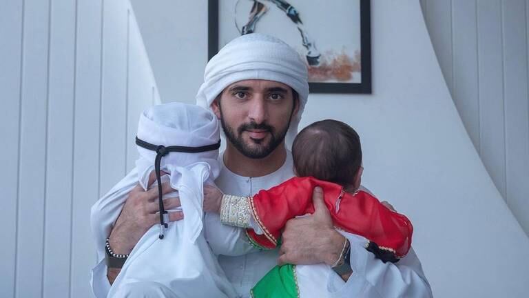 An image that illustrates this article Sheikh Hamdan poses with his twins in National Day post