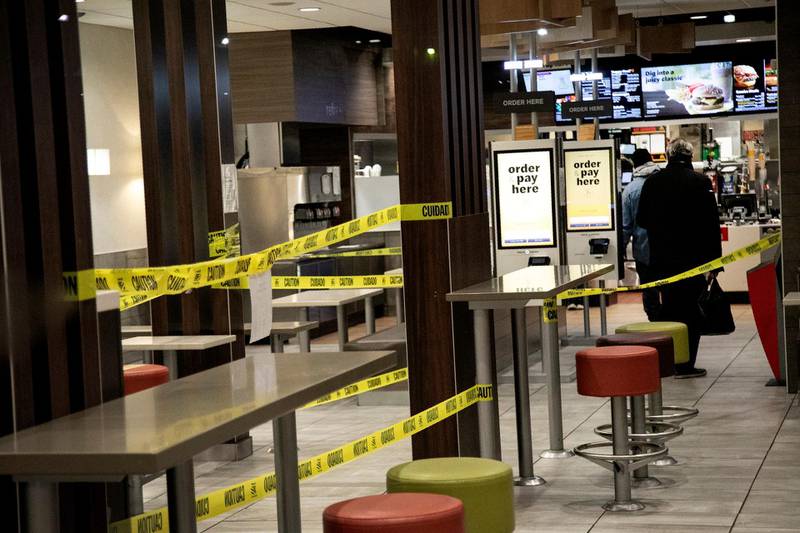 Customers at a McDonald's restaurant in Brooklyn, New York stand between cordons, as the restaurant is only preparing food for takeaway and delivery as part of its social distancing measures to slow the spread of coronavirus in the city. AP Photo