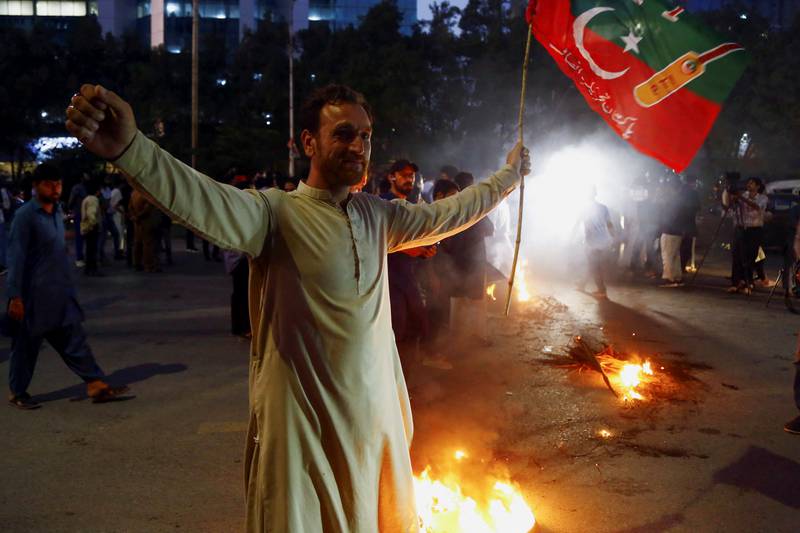 A Khan supporter in Karachi gestures during a protest following the shooting incident. Mr Khan was shot in the leg and has been admitted to hospital. Reuters