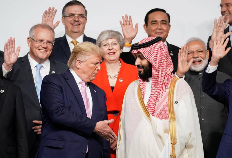 US President Donald Trump offers his hand to Saudi Arabia's Crown Prince Mohammed bin Salman during the family photo of G20 leaders at the Osaka Summit. Reuters