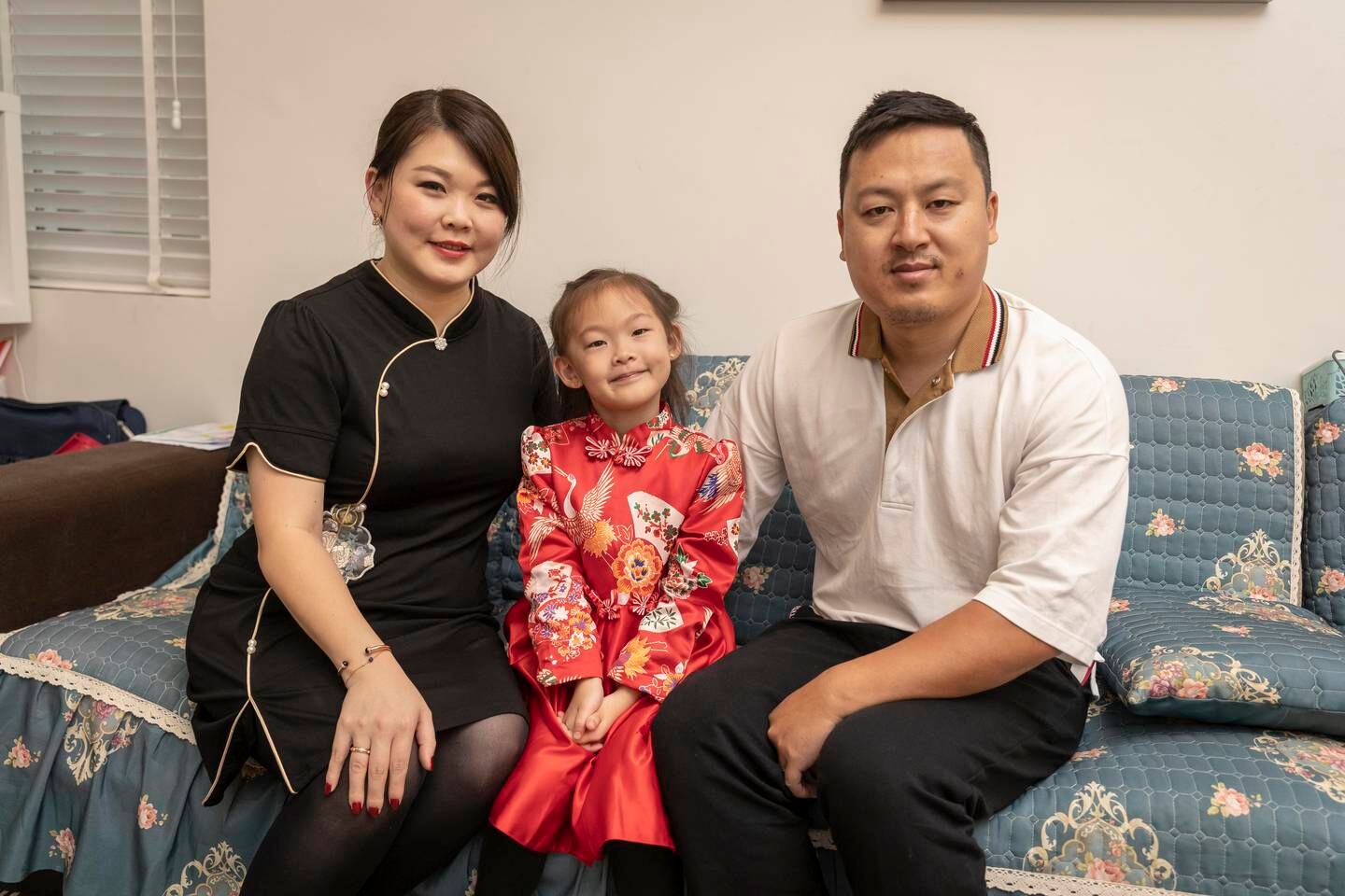Jiang Yanying at home with her husband and daughter in Dubai. Antonie Robertson / The National


