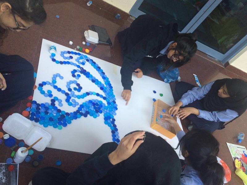 Pupils at Pristine Private School in Dubai make a mural using plastic bottle caps. Photo: Pristine Private School