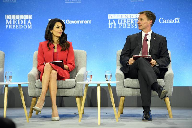 LONDON, ENGLAND - JULY 10: Human rights barrister Amal Clooney and Britain's Foreign Secretary Jeremy Hunt attend a discussion at the Global Conference on Press Freedom on July 10, 2019 in London, England. The conference sees speakers from around the world sharing their experiences and thoughts on protecting the rights of members of the media around the world. (Photo by Leon Neal/Getty Images)