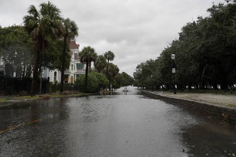 A car drives through a flooded street in Charleston. Willy Lowry / The National