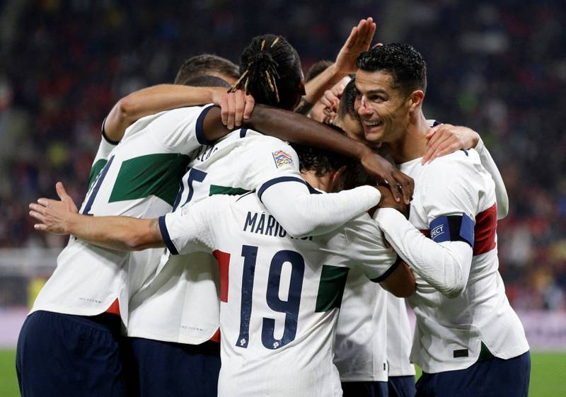 Diogo Dalot celebrates with teammates after scoring Portugal's third goal. Reuters