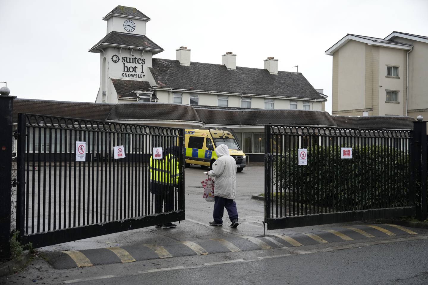 Police continue a presence outside the Suites Hotel in Knowsley, Merseyside, the morning after a protest and counter-protest. Getty Images