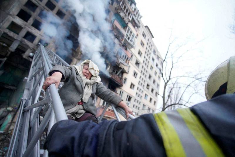 Rescuers free a woman from a residential building that was struck as Russia's attack on Ukraine continues, in Kyiv, Ukraine. March 14, 2022. Reuters