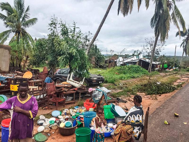 Assane Maulana rescues his belongings with his family in front of his home and shop in Macomia, following Cyclone Kenneth on April 28, 2019. Thousands of people in remote areas of storm-lashed Mozambique were homeless and bracing for imminent flooding April 27, food and water shortages as Cyclone Kenneth flattened entire villages, leaving rescuers struggling to reach them. AFP
