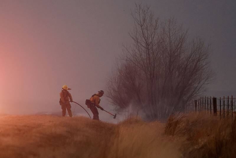 Firefighters work to create a firebreak near Boulder. Reuters