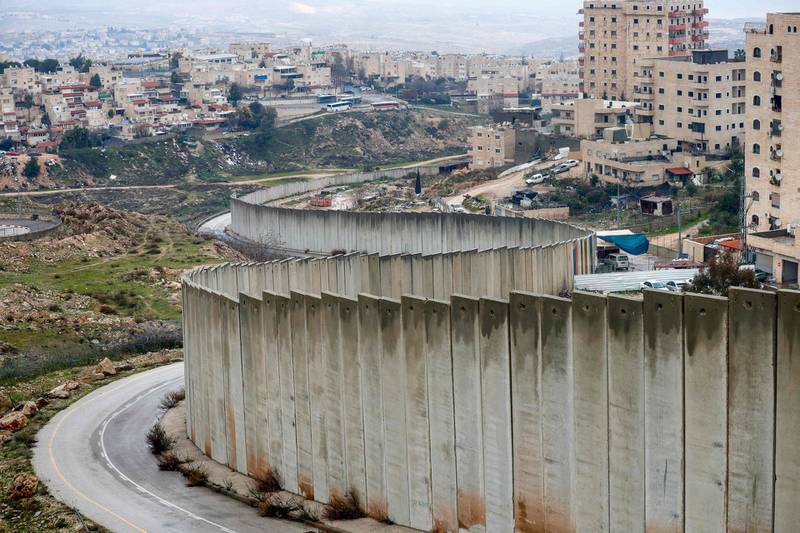 The Israeli settlement of Pisgat Zeev on the left is built in a suburb of the mostly Arab east Jerusalem, and the Palestinian Shuafat refugee camp on the right sits behind Israel's controversial separation wall.  AFP
