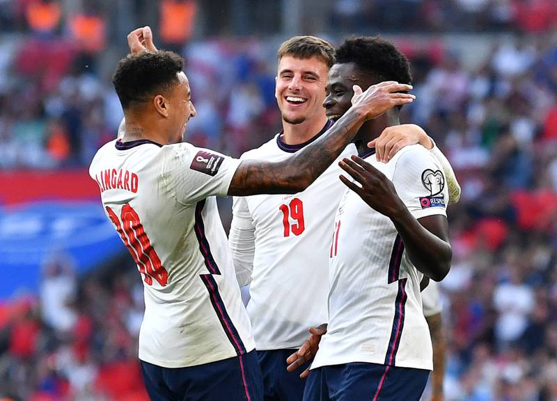 England's Bukayo Saka, right, celebrates scoring England's fourth goal. Reuters