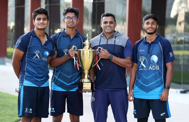 Jash Giyanani, Nilansh Keswani, coach Qasim Ali and Abhay Katoch with the ECB National Academy League 2021-2022 trophy at the ICC Academy in Dubai. 