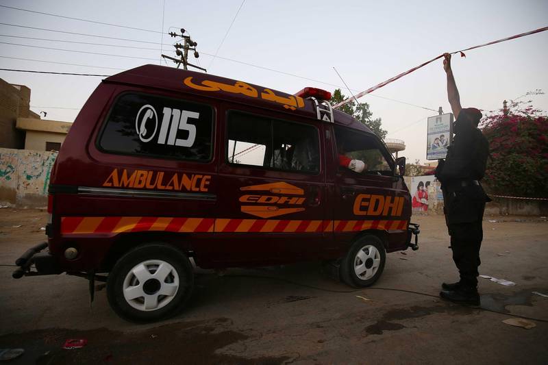 Pakistani security officials stand guard a day after a passenger plane of state run Pakistan International Airlines crashed in a residential area, in Karachi, Pakistan. EPA