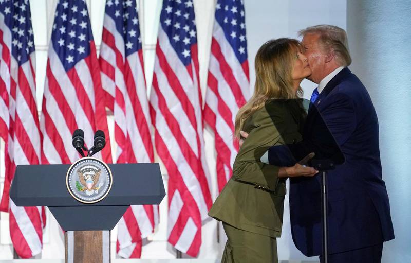 US first lady Melania Trump is hugged and kissed by US President Donald Trump after delivering her live address to the largely virtual 2020 Republican National Convention from the Rose Garden of the White House in Washington. Reuters
