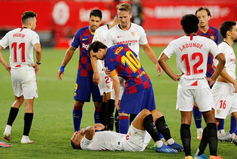 Lionel Messi stands over Sevilla's Diego Carlos. Reuters