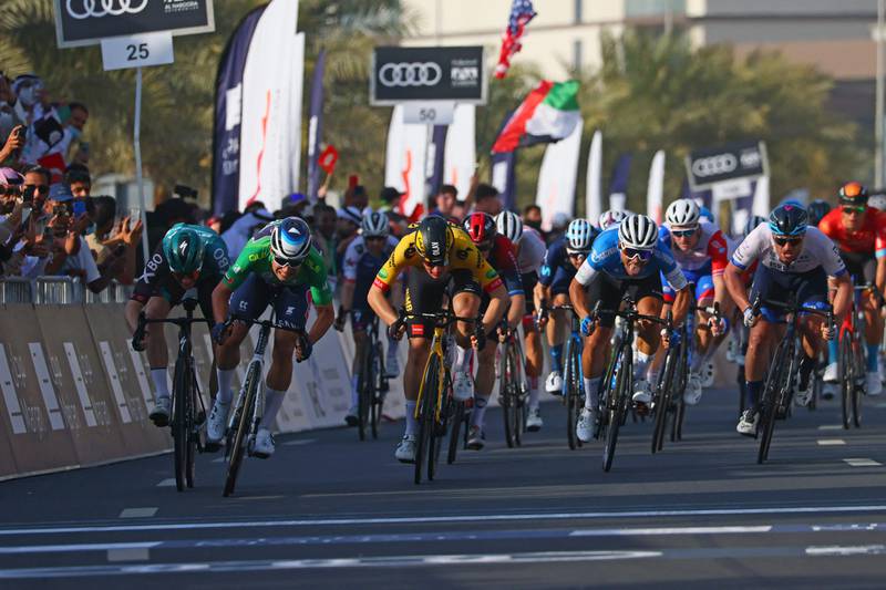 Jasper Philipsen, second left, crosses the finish line to win Stage Five of the UAE Tour. AFP