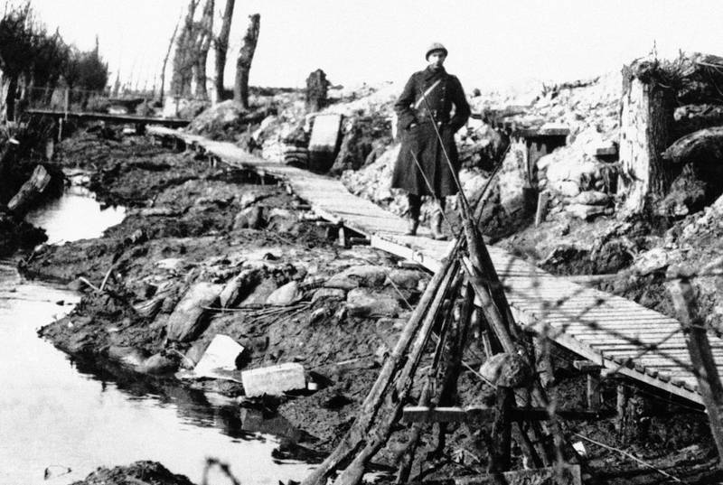 A soldier walks along wooden planks placed over the mud of Flanders' Fields near the Yperlee Canal near Ypres, Belgium.