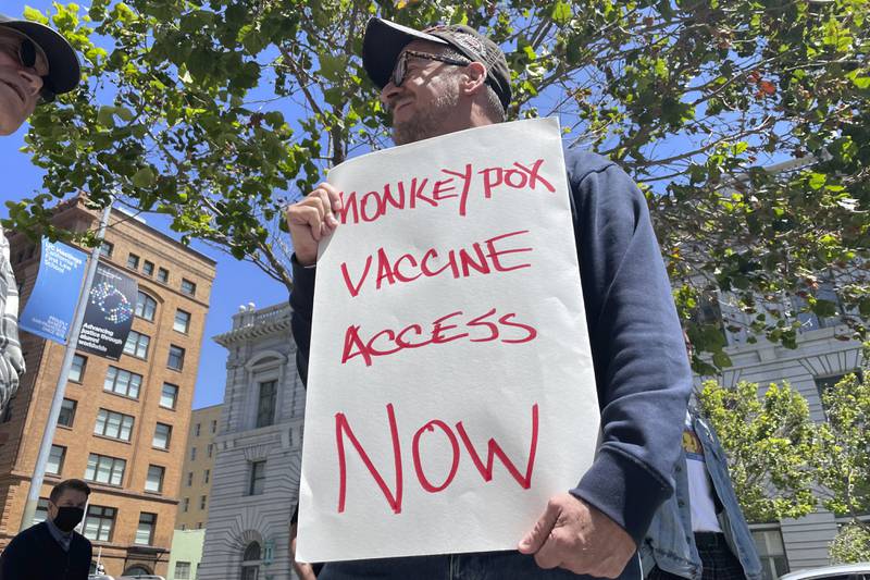 A man holds a sign urging increased access to the monkeypox vaccine during a protest in San Francisco, California. AP