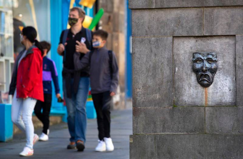 Tourists roam the normally busy Royal Mile in Edinburgh, Scotland. AP Photo
