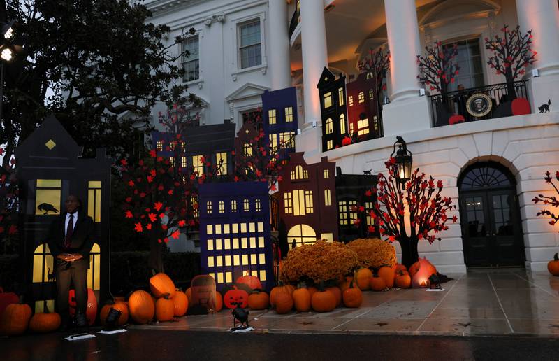 A US Secret Service Agent stands watch from the shadows of the Halloween-decorated South Portico at the White House in Washington. Reuters