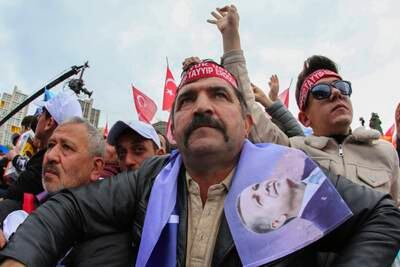 Supporters listen to Mr Erdogan's address in Ankara on Sunday. AP