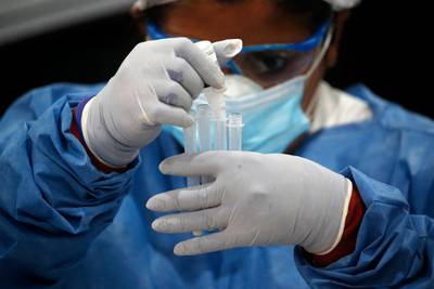 A healthcare worker tests for Covid-19, in Buenos Aires, Argentina. AP Photo