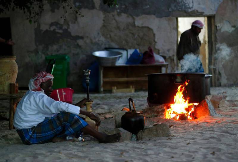 An Emirati man prepares traditional food.