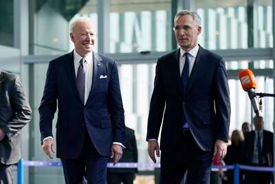 Mr Biden is greeted by Mr Stoltenberg as he arrives for meetings with Nato allies in the Belgian capital. AP Photo