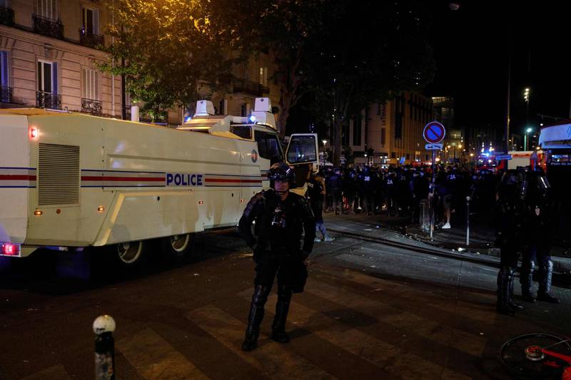 French police block a street. AFP