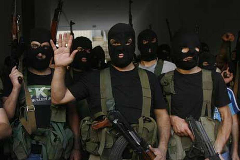 Lebanese masked gunmen from the Al Muqdad clan gather for a press conference in Beirut's southern suburbs.