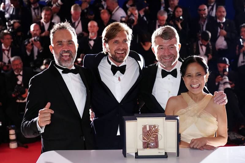 Dolly De Leon, far right, with Ruben Ostlund, second left, winner of the Palme d'or Prize for 'Triangle of Sadness', Erik Hemmendorff and Philippe Bober during the Award Winners' photocall at the 75th annual Cannes Film Festival, in Cannes, France on May 28, 2022. EPA
