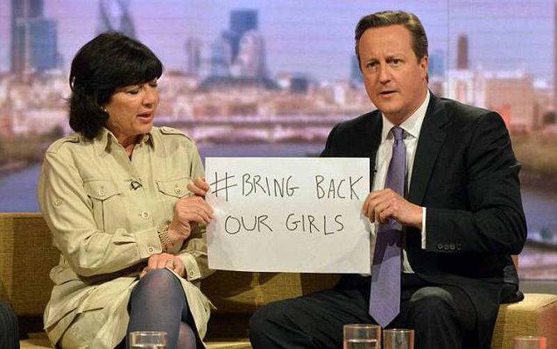 CNN anchor Christiane Amanpour and prime minister David Cameron hold up the sign #Bring Back Our Girls in support of the kidnapped Nigerian girl students. Courtesy CNN