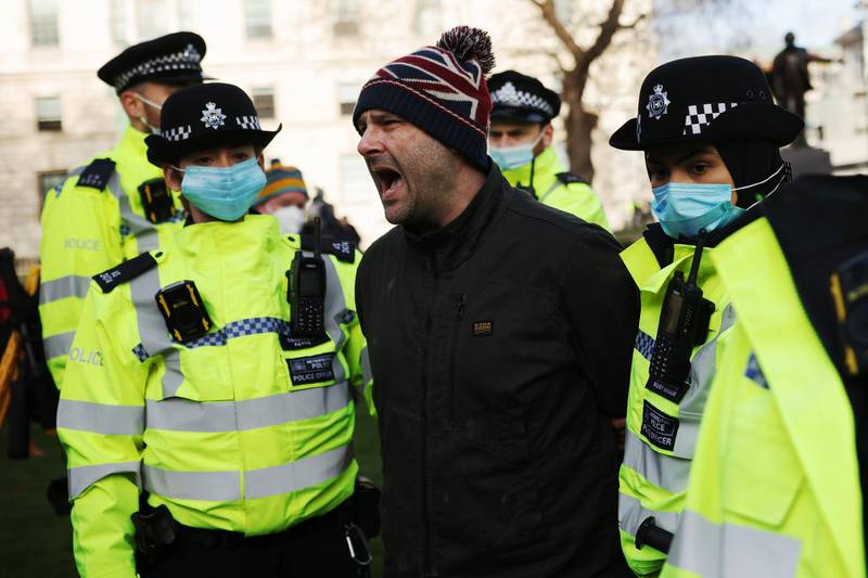 An anti-lockdown protester is arrested by police officers in Parliament Square outside the House of Commons in London, England. The UK Parliament has been recalled today to debate and vote on the new regulations needed to reimpose the England-wide lockdown that was announced by Prime Minister Boris Johnson on Monday night. Getty Images