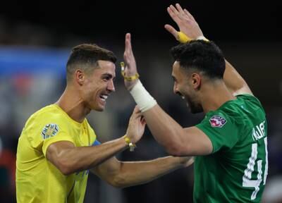 Cristiano Ronaldo and Nawaf Alaqidi of Al Nassr celebrate after their victory. Getty