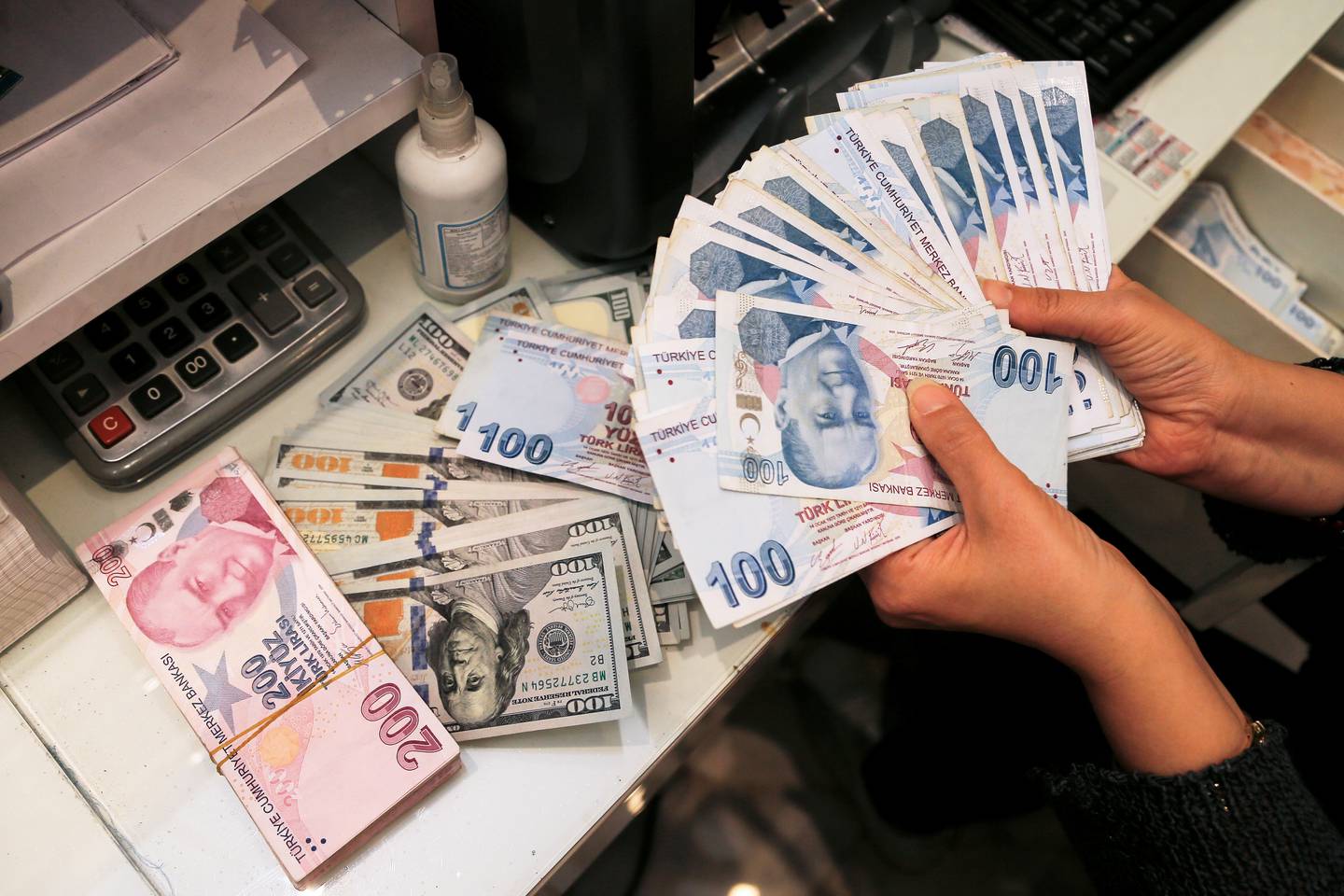 A money changer holds Turkish lira banknotes at a currency exchange office in Ankara last week. Reuters