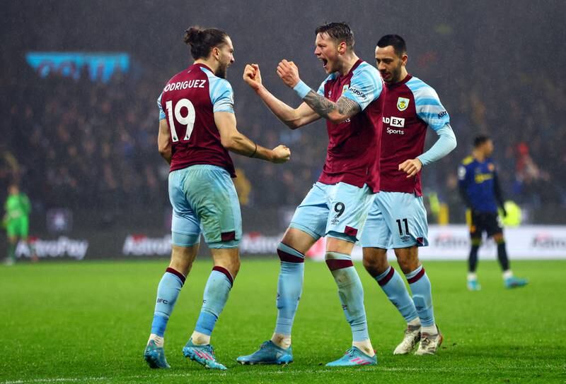 Burnley's Rodriguez, right, celebrates with Weghorst and Dwight McNeil after making it 1-1. Getty